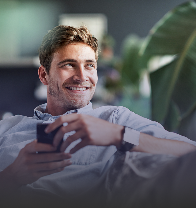 Man in a shirt holding a mobile phone